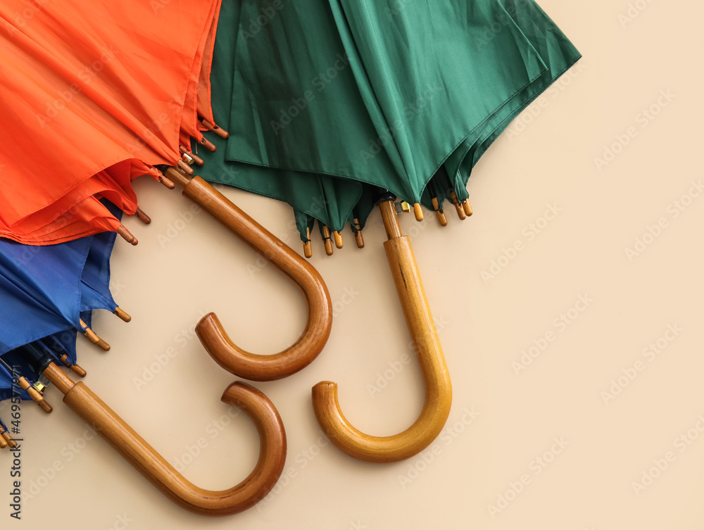 Different umbrellas on color background, closeup