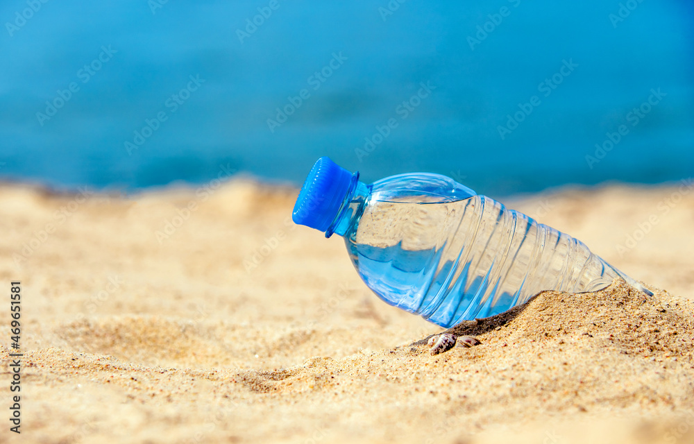 A bottle of drinking water on the sea beach
