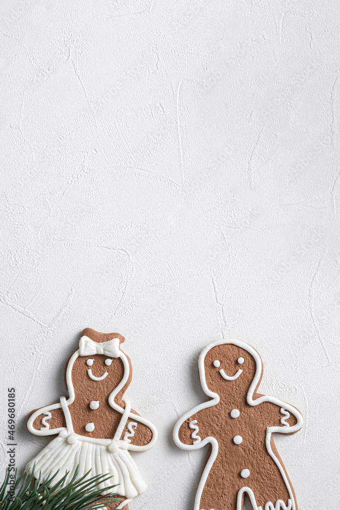 Decorated Christmas gingerbread cookies with decorations on white table background.