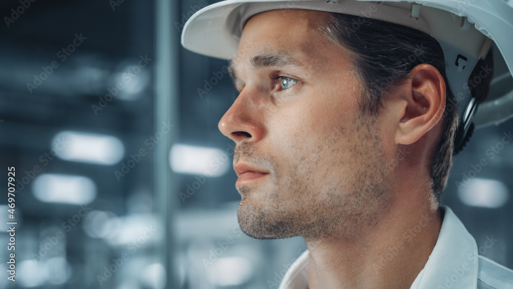 Portrait of a Young Handsome Confident Engineer Wearing White Hard Hat in Office at Car Assembly Pla