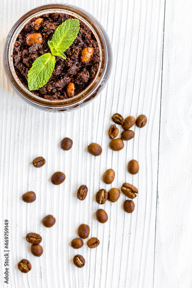 Spa concept with coffee scrub on white background top view