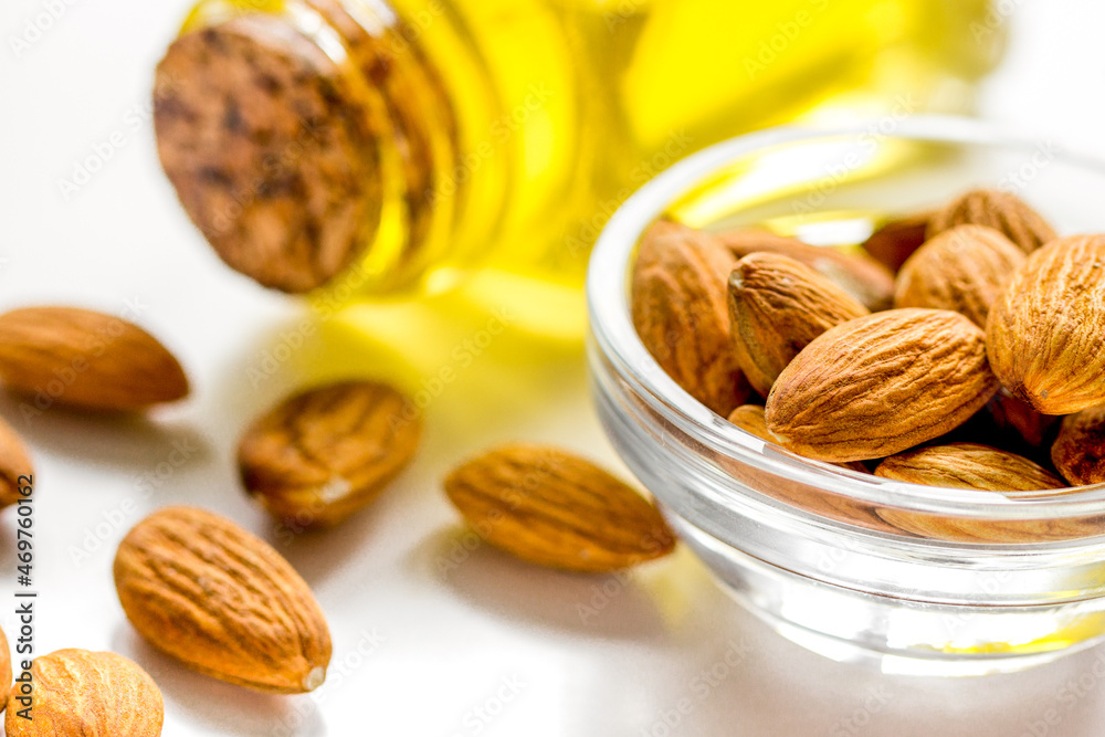 spa with almond oil in organic cosmetic set on white background