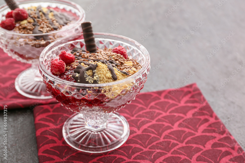 Tasty dessert with flax seeds and yoghurt in glass on dark background