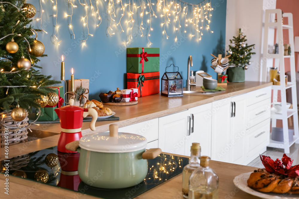 Cooking pot on stove in kitchen decorated for Christmas