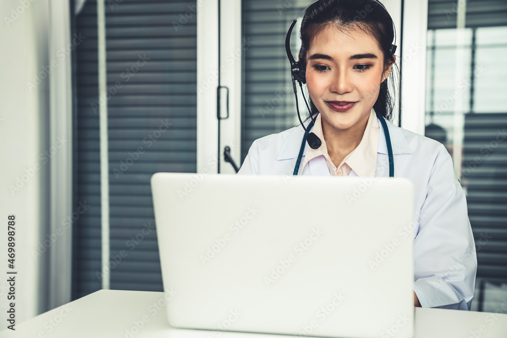 Doctor wearing headset talking actively on video call in hospital or clinic . Concept of telehealth 