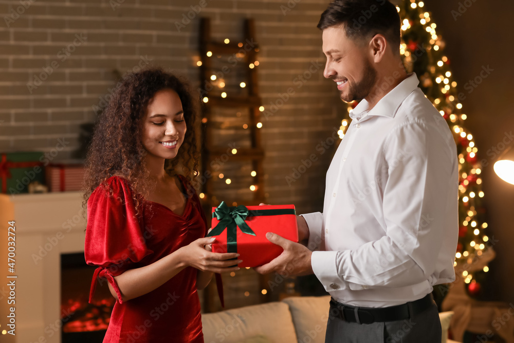 Man greeting his wife on Christmas eve at home