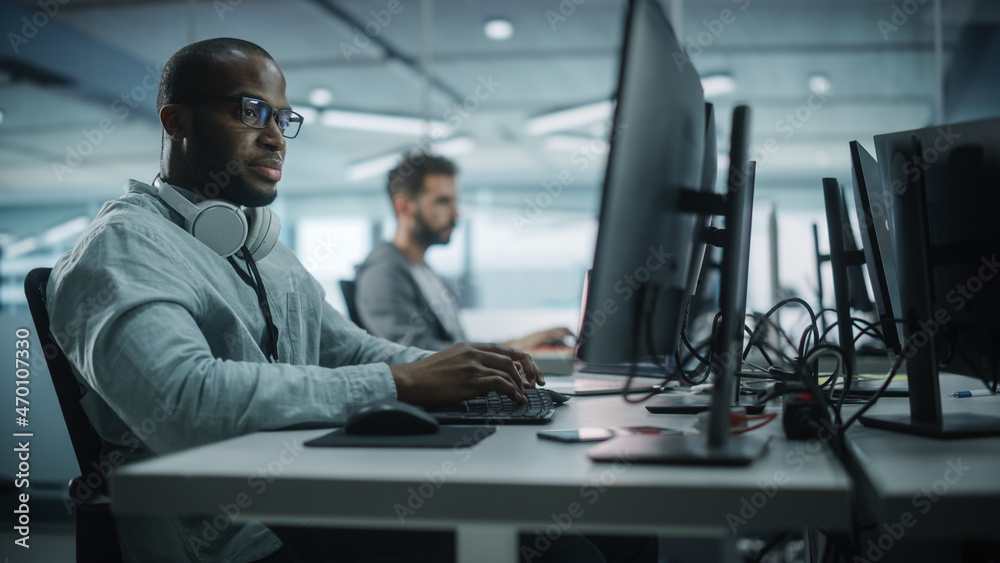 Diverse Office: Black IT Programmer Working on Desktop Computer. Male Specialist Creating Innovative