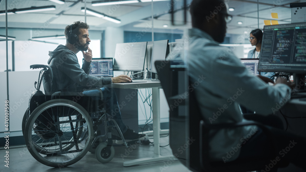 Disability-Friendly Office: Amazing IT Programmer with Disability in a Wheelchair Working on Desktop