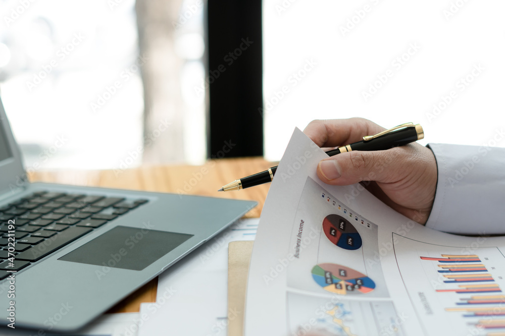 Close up of accountant or banker checking investment results, calculates financial savings, calculat