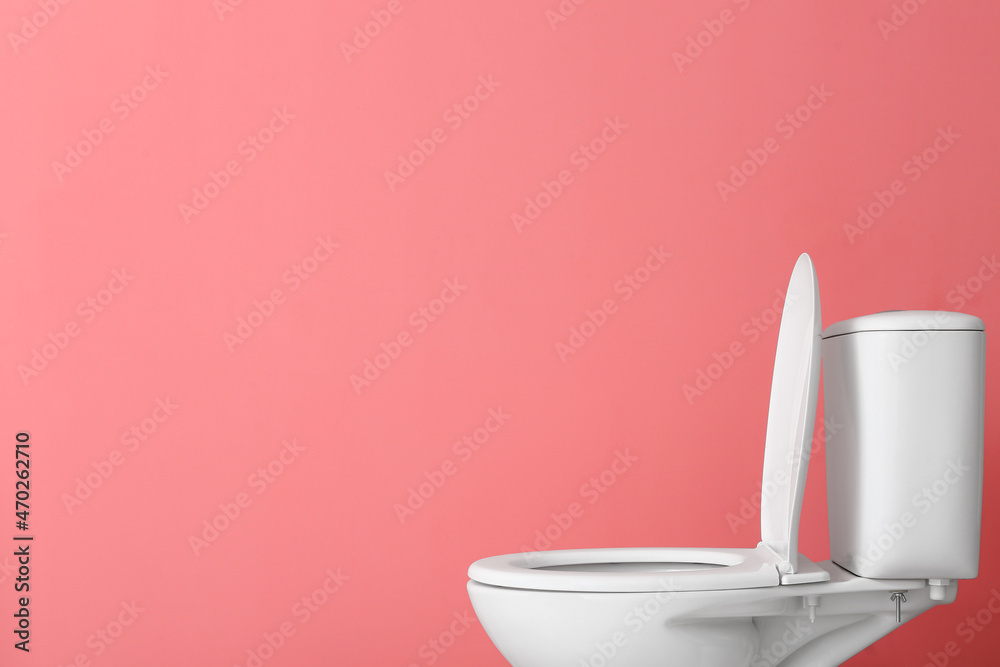 Toilet bowl on pink background