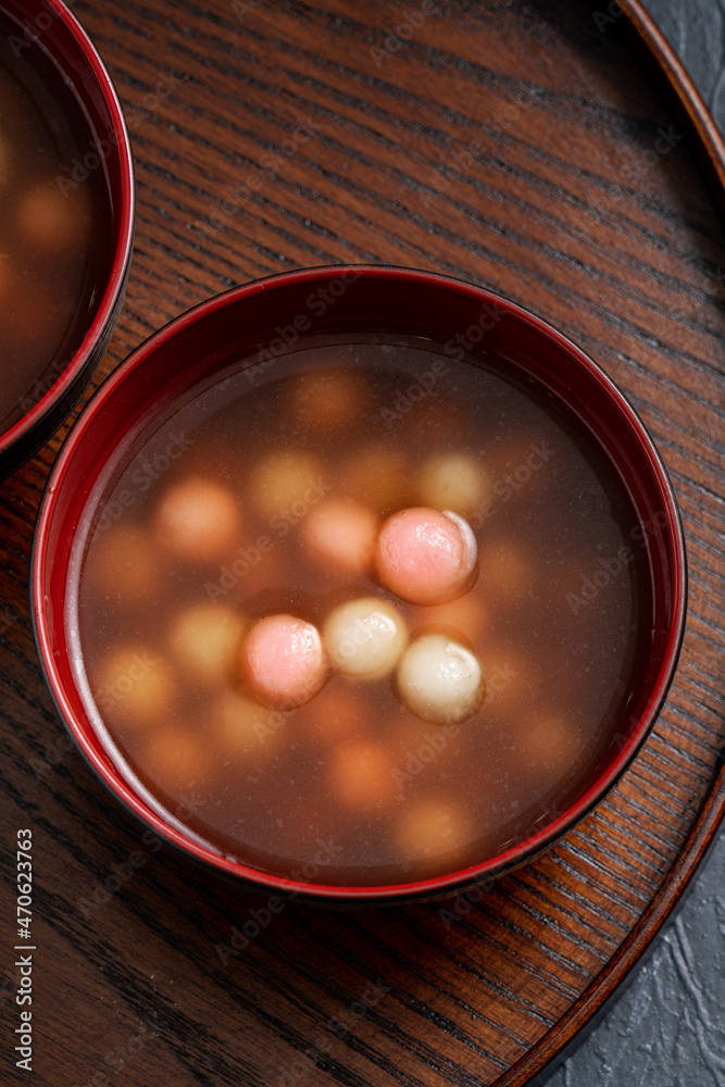 Red and white tangyuan with syrup soup.