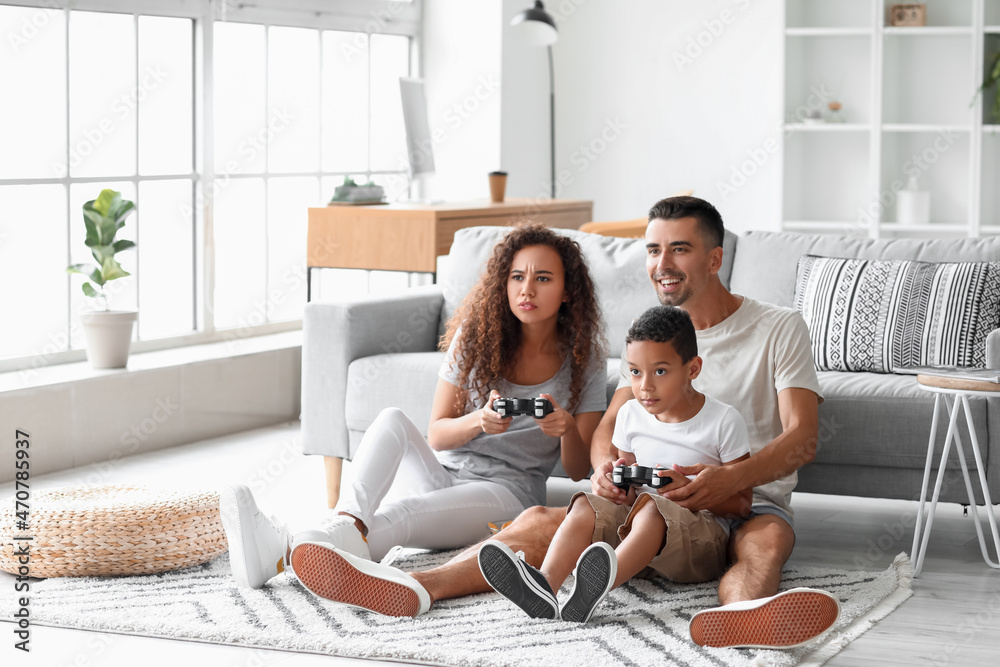 Happy interracial family playing video game at home