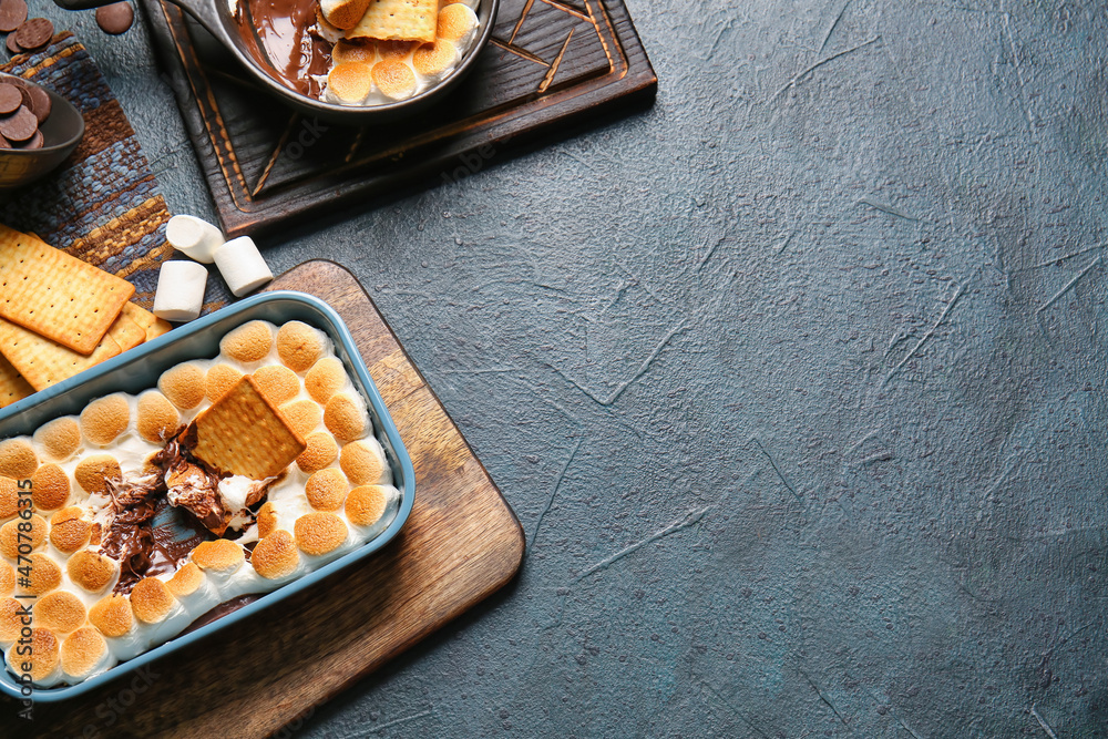 Composition with tasty Smores dip and crackers on dark background