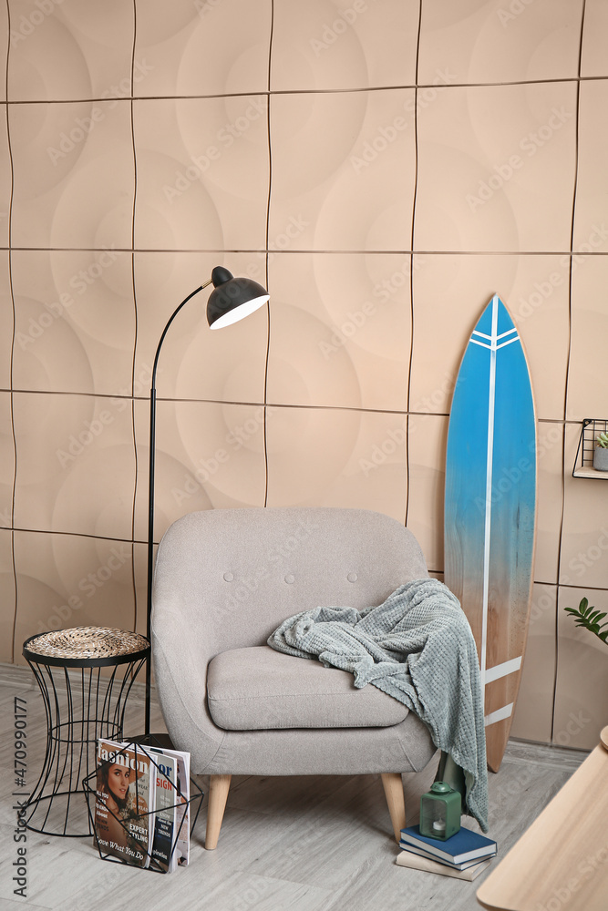 Armchair with surfboard in interior of stylish modern room