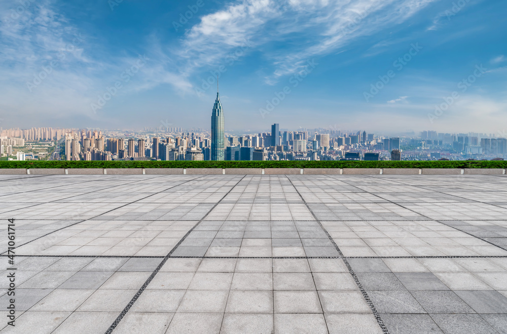 Empty brick floor with city skyline background