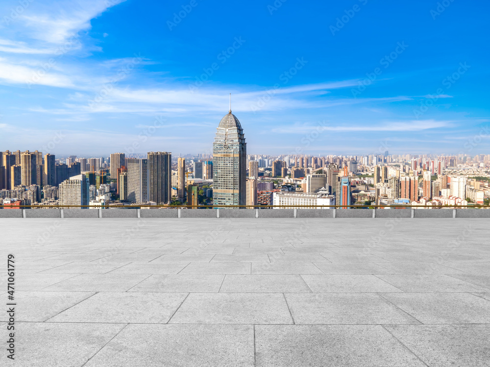 Empty brick floor with city skyline background