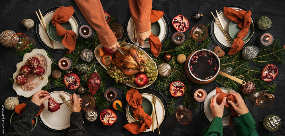 People feasting with roast chicken and hot wine for Christmas