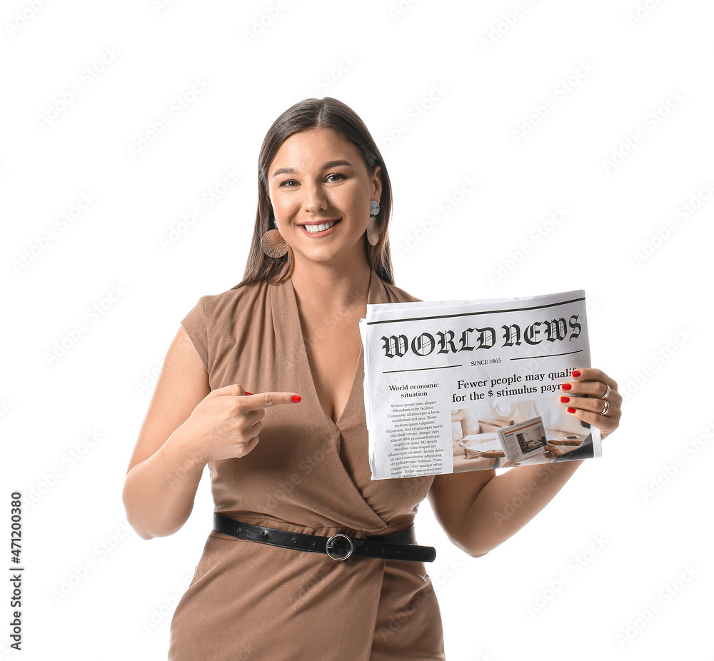 Smiling businesswoman pointing at newspaper on white background