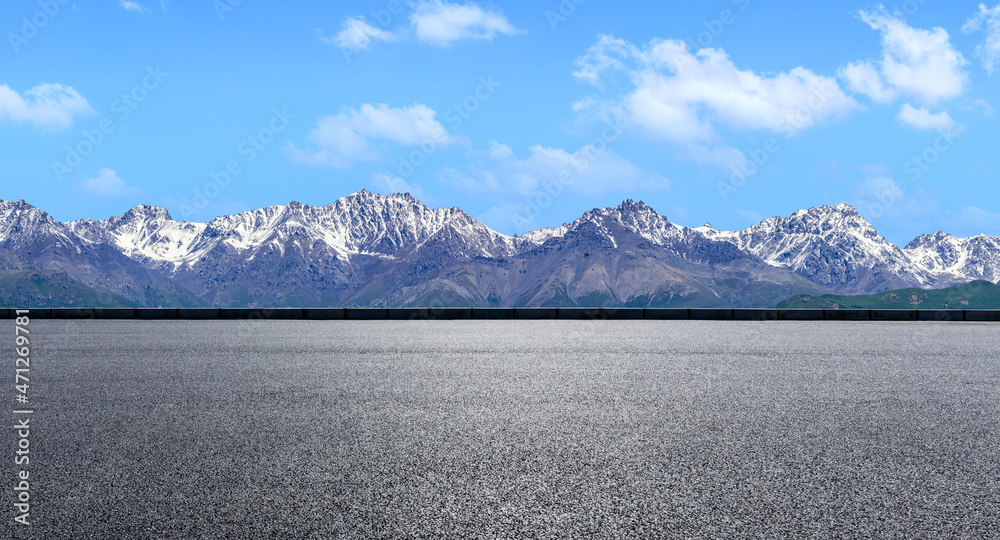 Asphalt road and mountain under blue sky. Highway and mountain background.