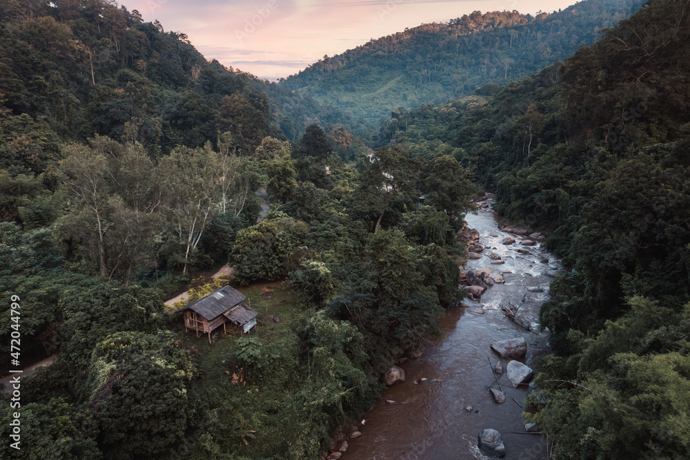 热带雨林中的木屋和山谷中的天然急流