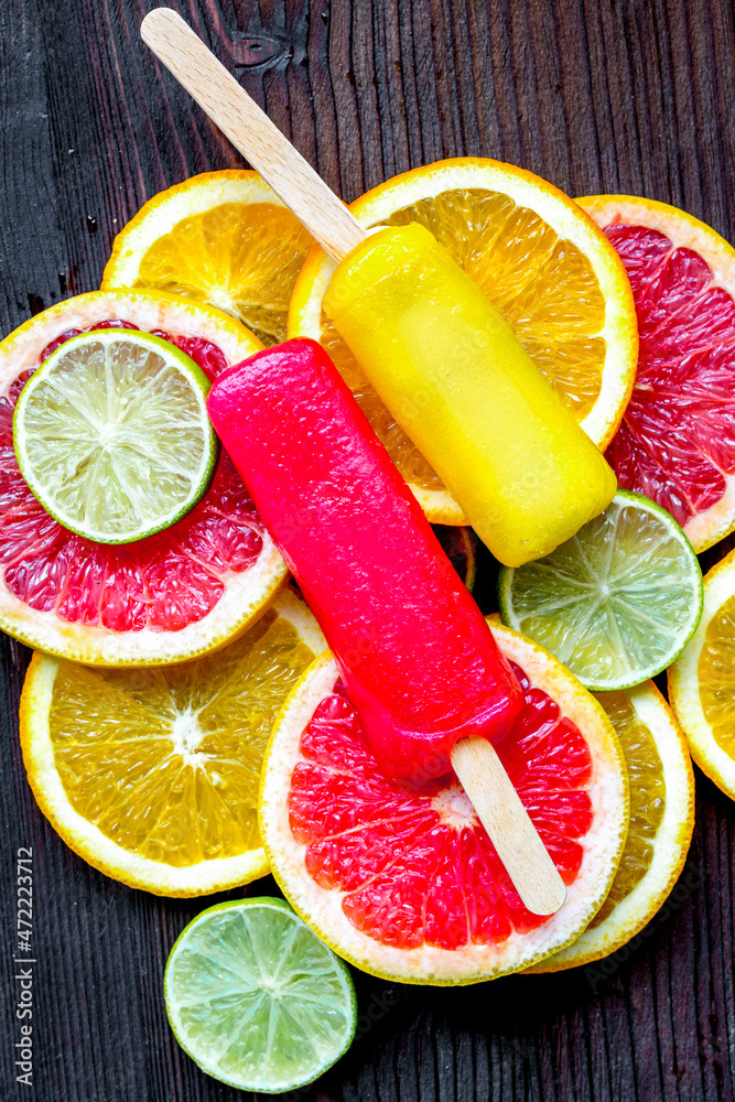 Orange icecream with fruits on table background top view