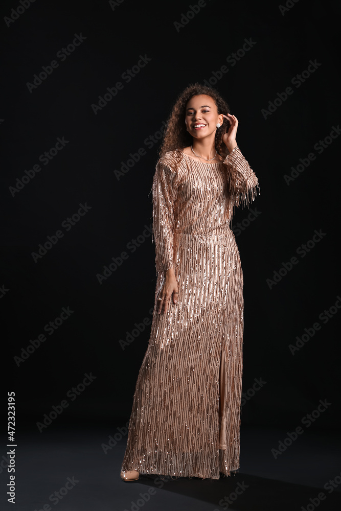 Fashionable African-American woman on dark background