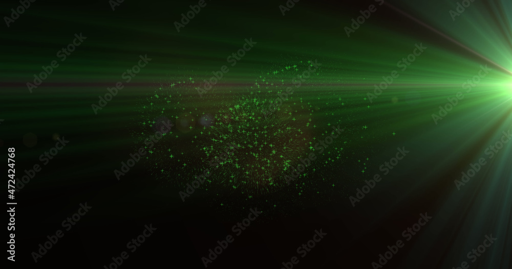 Image of green light beams with christmas and new year fireworks exploding in night sky