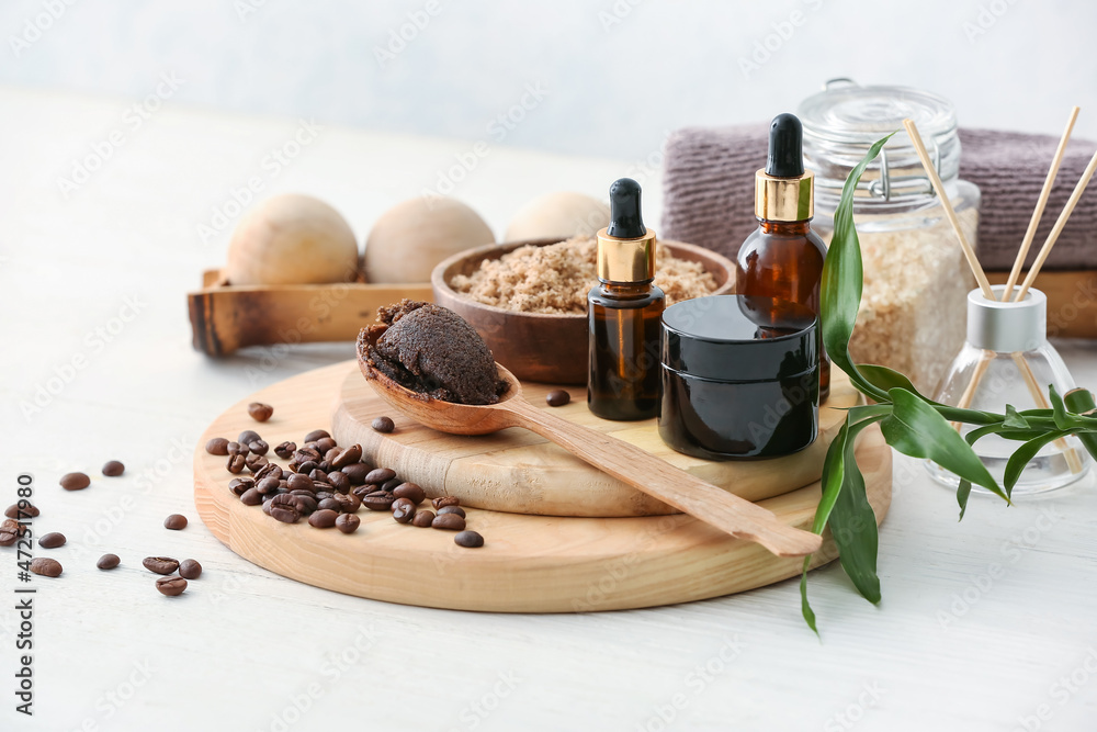 Spa set with coffee scrub on light background