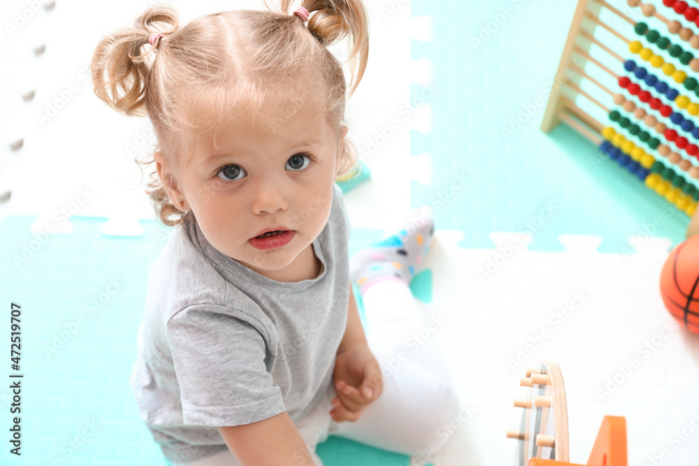 Cute baby girl playing at home