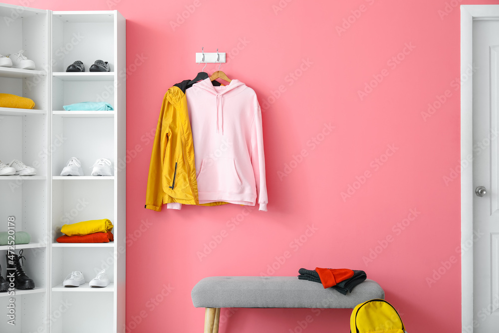 Dressing room with stylish hoodie hanging on wall