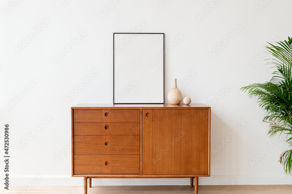 Blank picture frame on a wooden cabinet