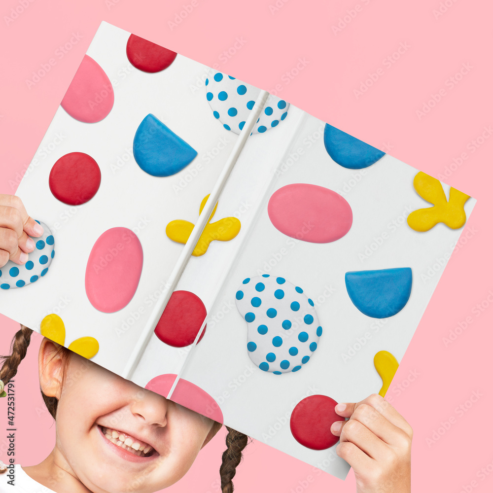 Cute clay patterned children’s book cover held by a girl