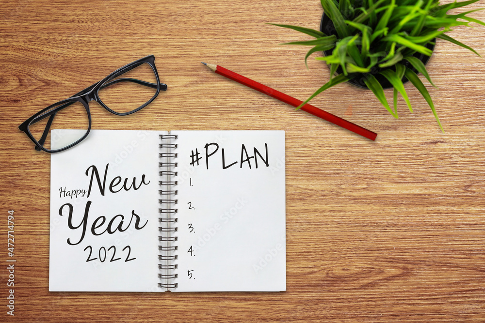 2022 Happy New Year Resolution Goal List and Plans Setting - Business office desk with notebook writ