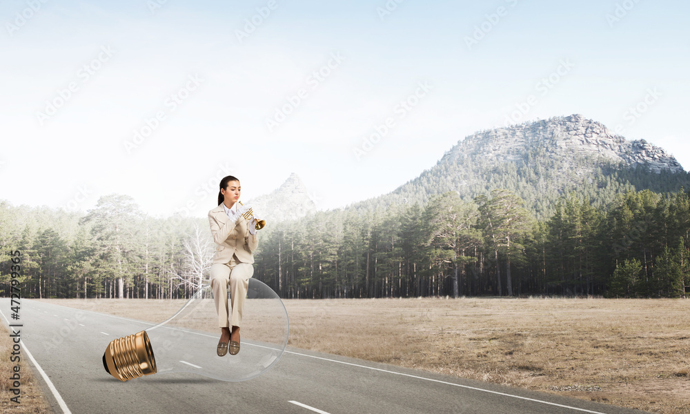 Attractive woman playing trumpet brass