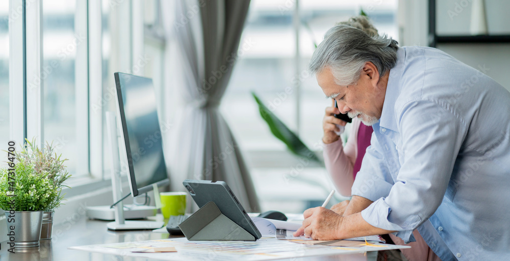 asian senior copule working at home,retired old asian male and his wife hand use smartphone discuss 