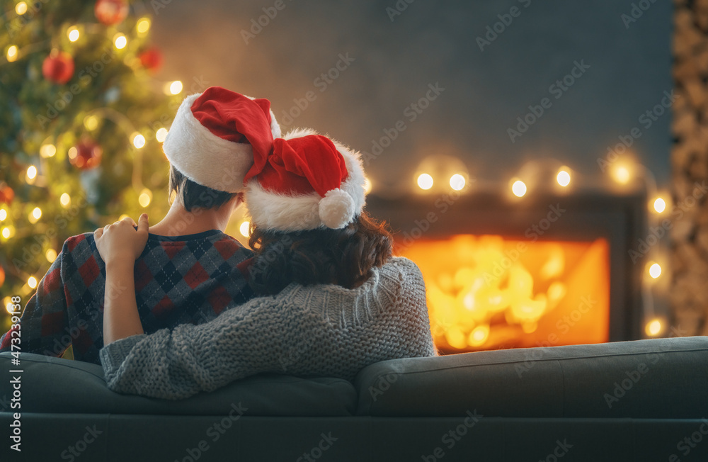 couple relaxing near Christmas tree