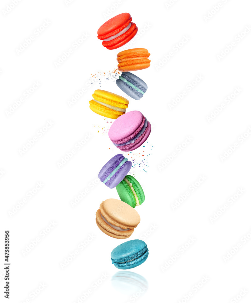 Сolored macaroons with different flavors in the air on a white background