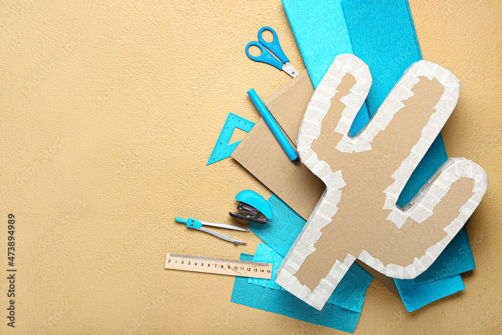 Preparation of Mexican pinata on color background