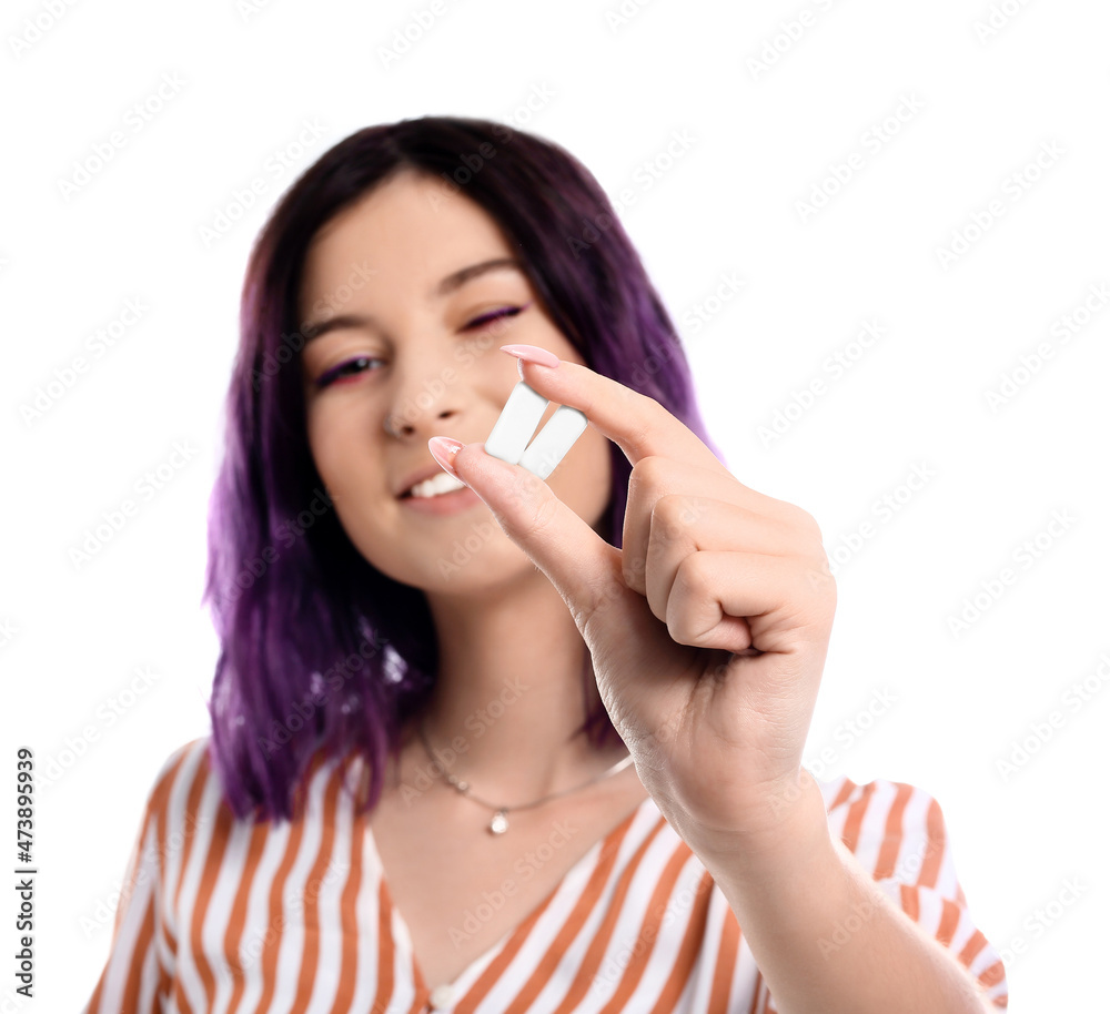 Young woman with chewing gums on white background