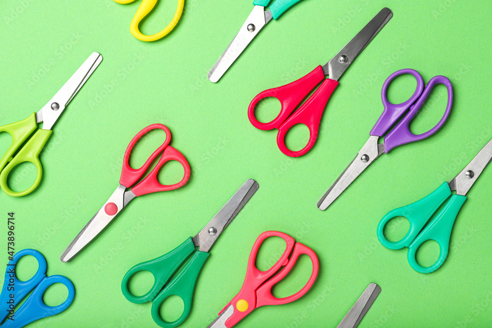 Many scissors on color background