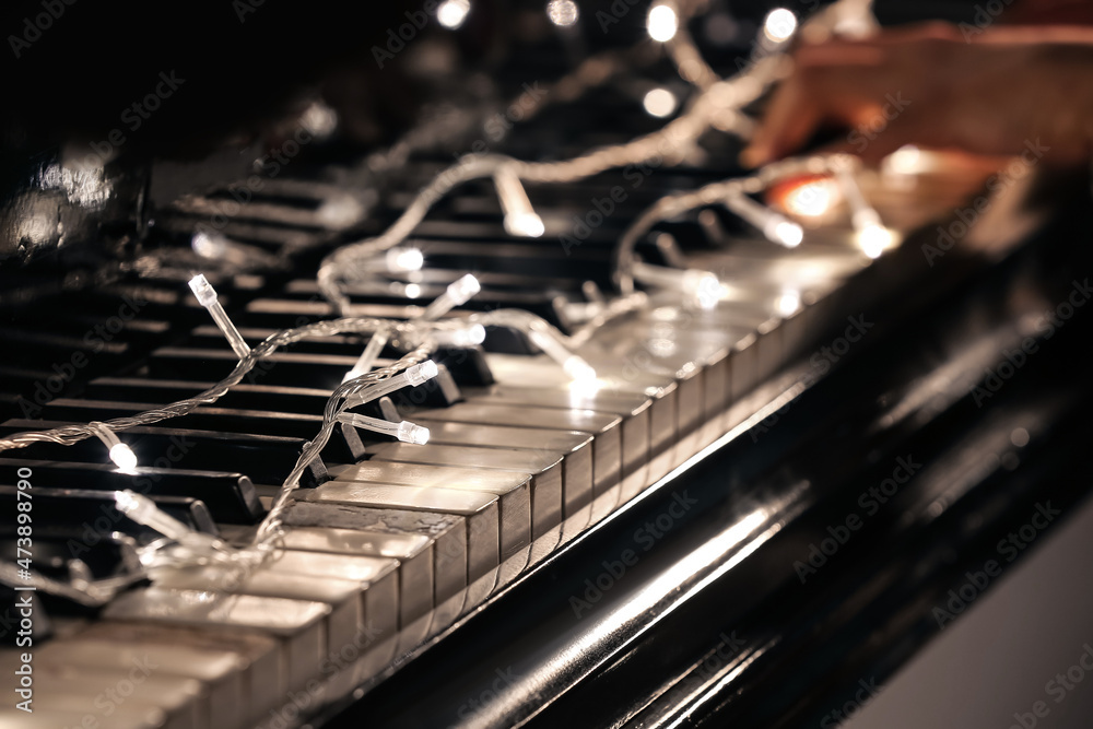 Christmas glowing lights on piano, closeup