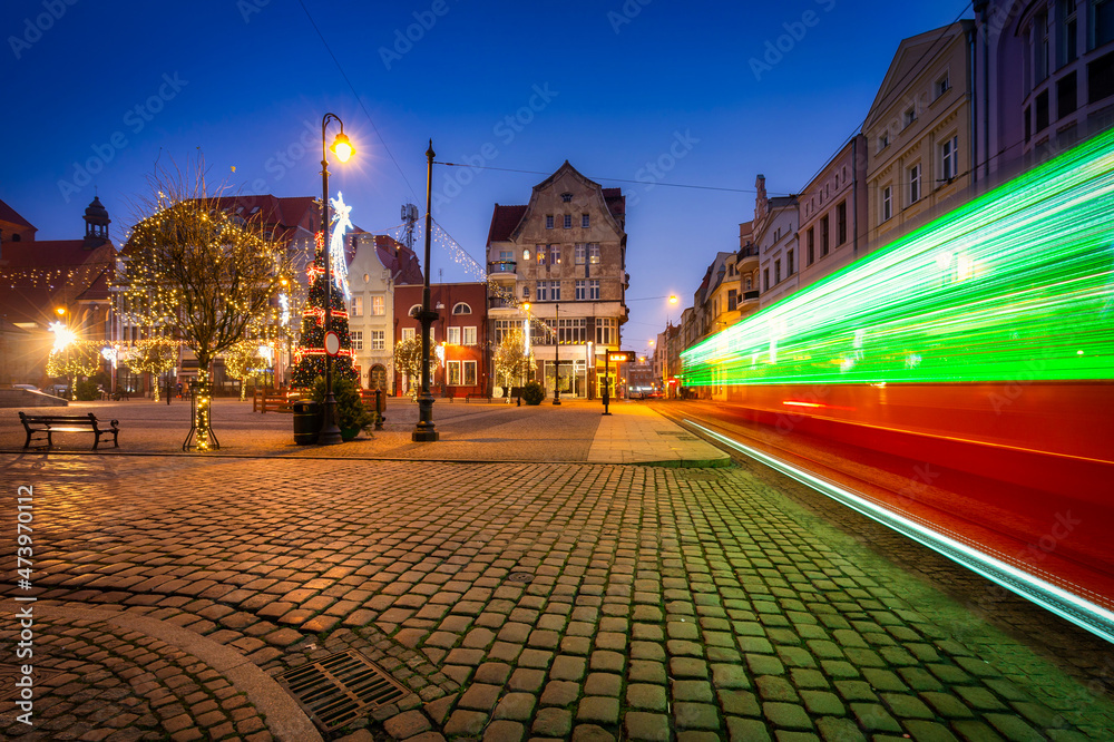 Christmas tram and decorations at the market square in Grudziądz at dusk. Poland