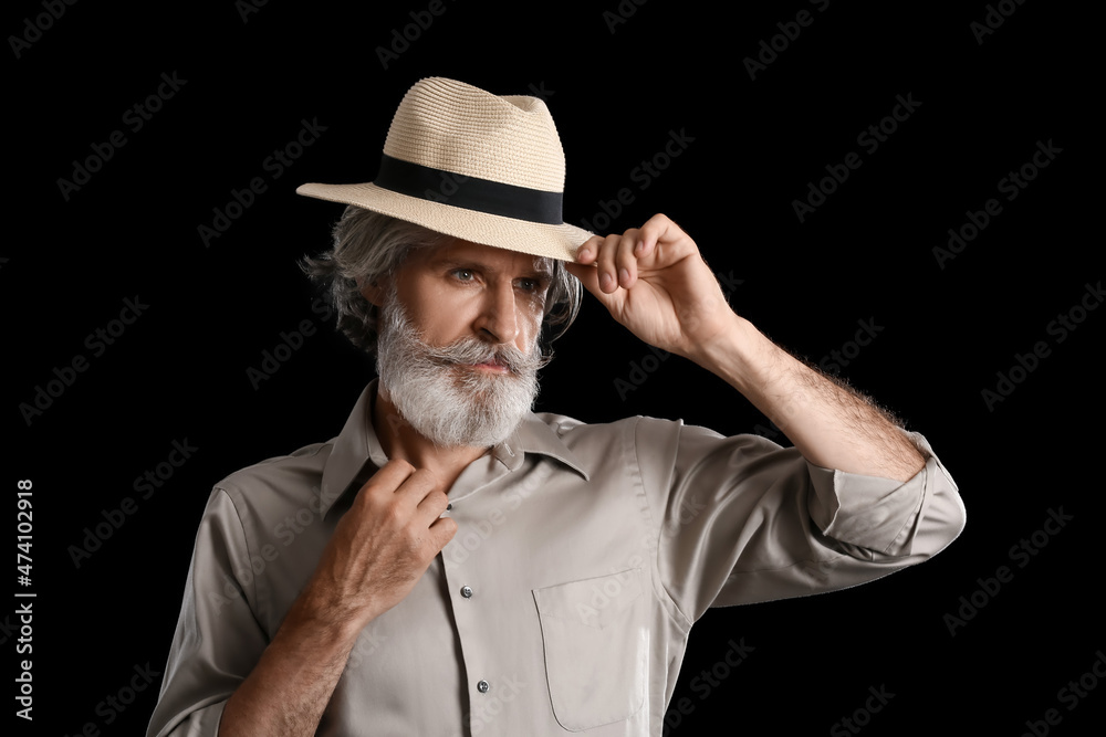 Fashionable mature man on dark background