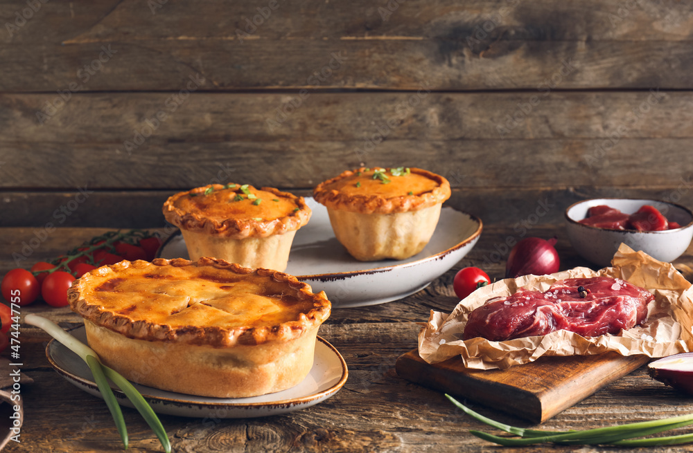 Tasty beef pot pies with meat on table