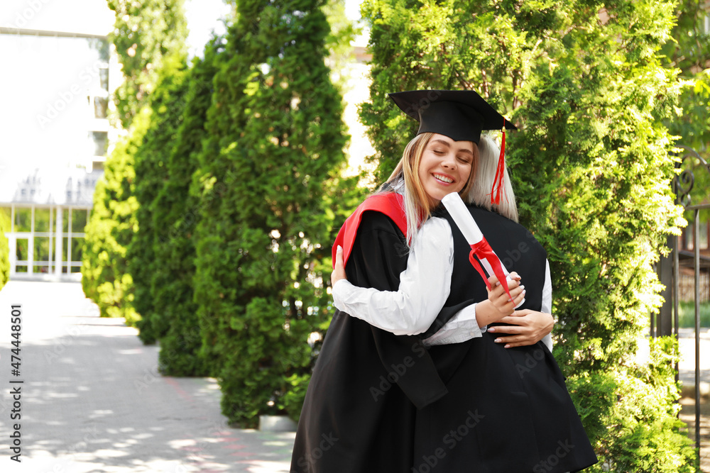 Happy young woman with her mother on graduation day