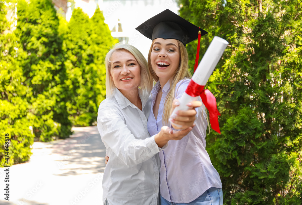 Happy young woman with her mother on graduation day