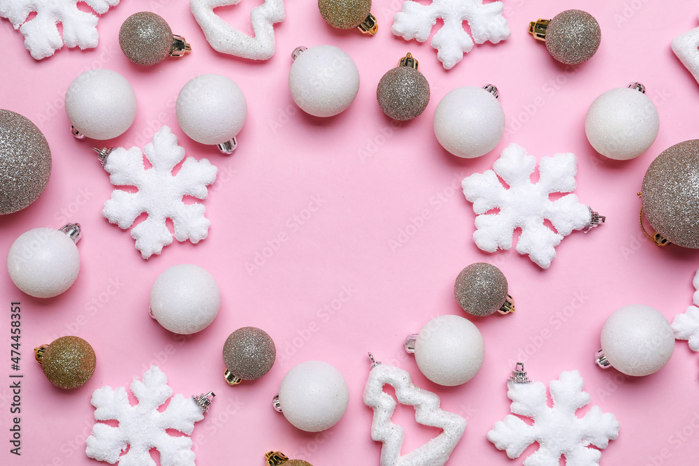 Frame made of Christmas decorations on pink background