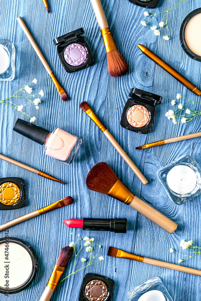 cosmetic set with eye shadow on woman table background top view