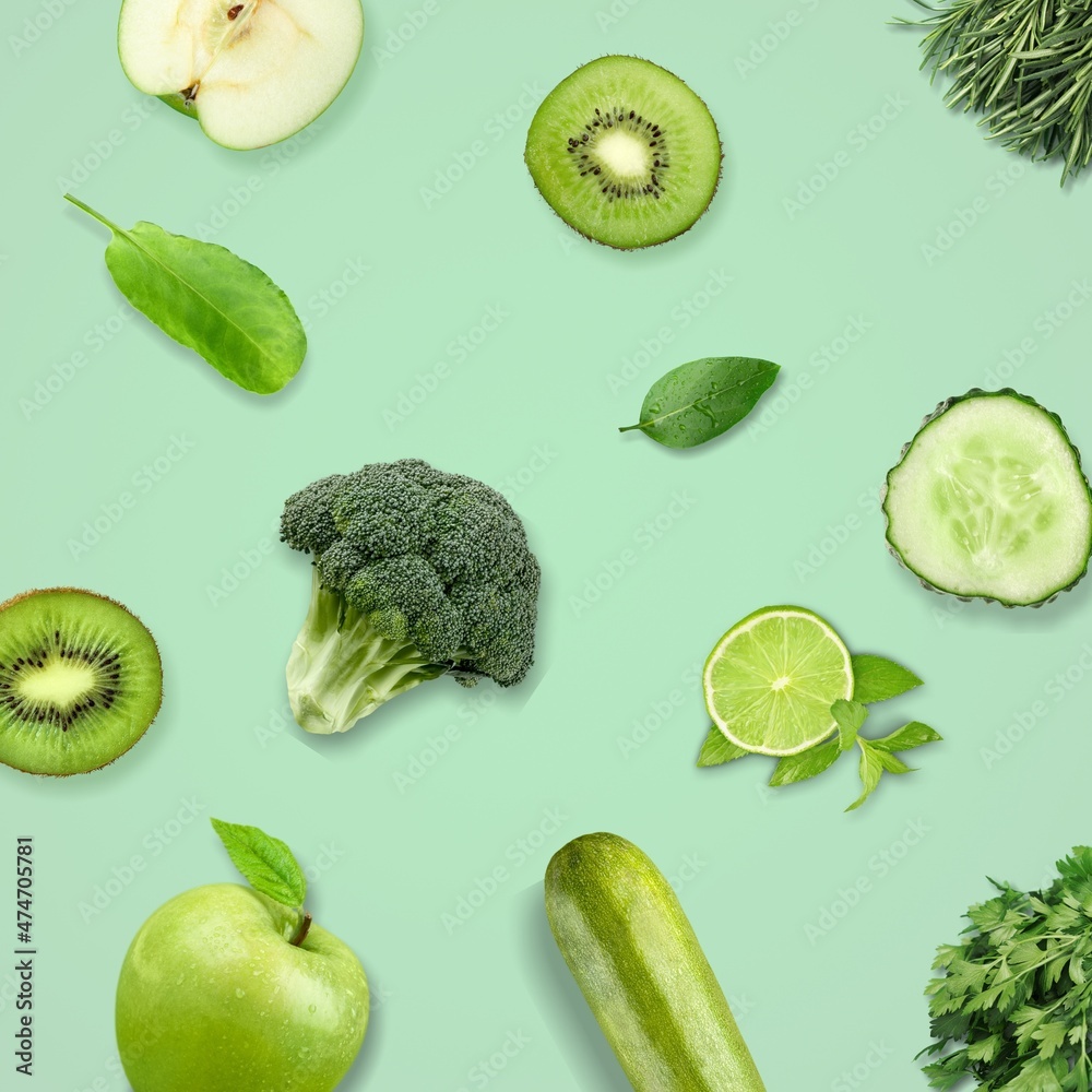 Creative kiwi, cucumber, apple, green peas on the green background. Food concept.