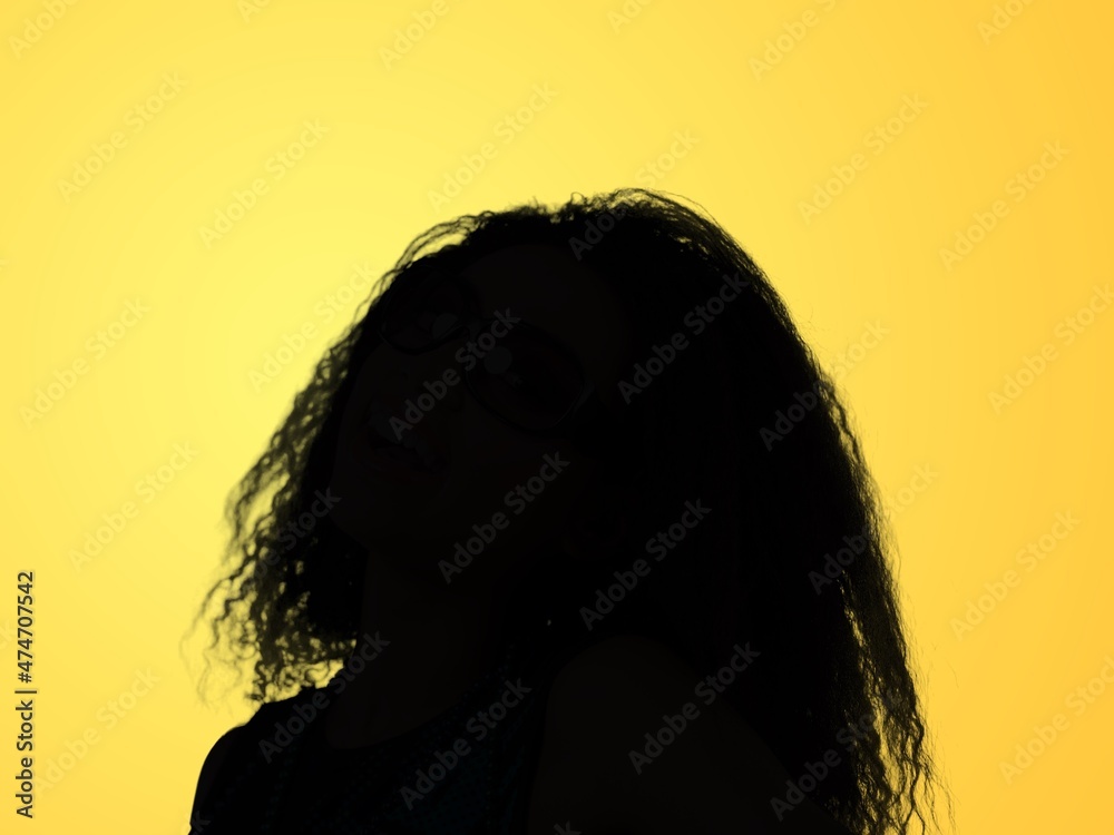 Black profile of an woman on a background, shaded silhouette, head and shoulders.